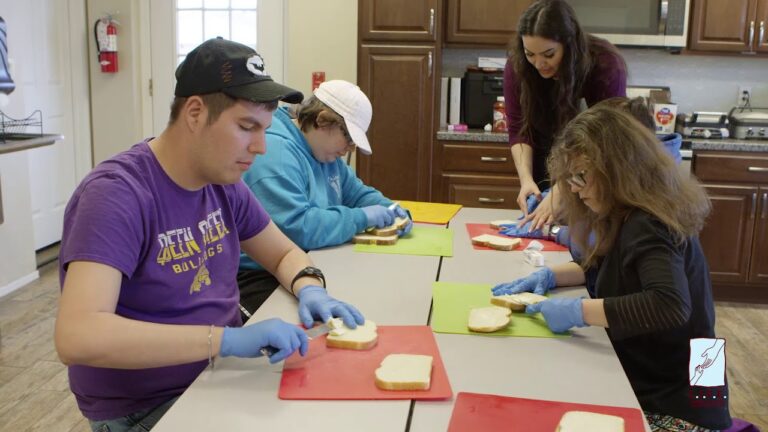 Adults enjoying a supported craft activity together.